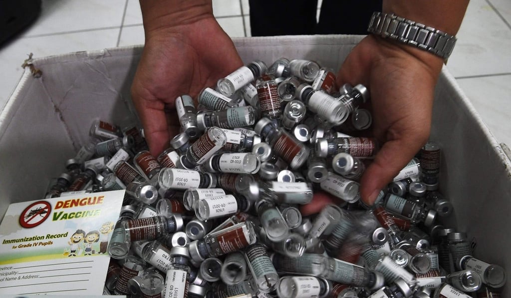 A medical worker displays used vials of Sanofi's dengue vaccine in Manilla. Photo: AFP