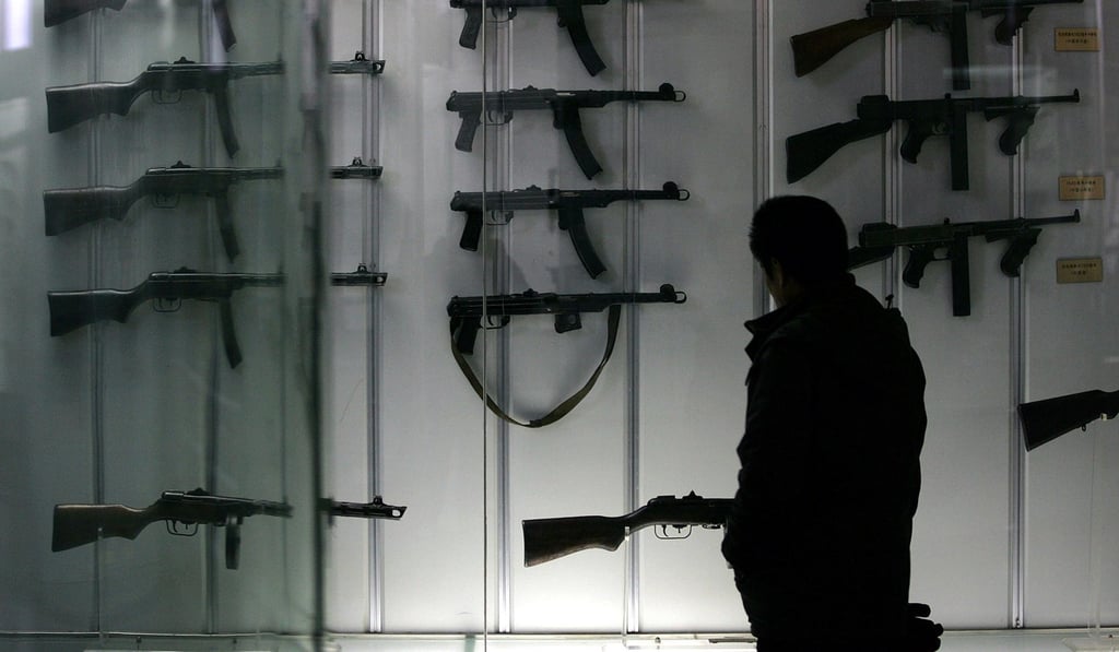 A visitor looks at old Chinese-made machine guns at a military museum in Beijing. China now focuses on intangible transfers in the form of research cooperation and investment in hi-tech firms. Photo: AFP