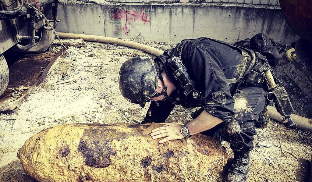 Bomb disposal officer Adam Roberts inspects the 220kg bomb at Pok Fu Lam last month. Photo: Handout