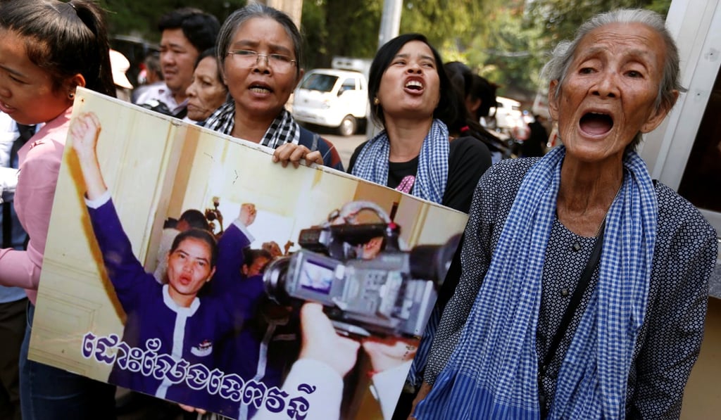 Protesters hold a portrait of the land rights activist Tep Vanny in front of the Supreme Court during her appeal hearing. Photo: Reuters