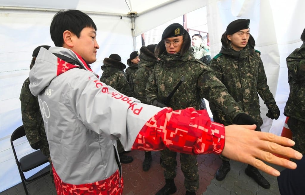South Korean soldiers inspect a visitor at a security checkpoint as they replace security guards showing symptoms of the norovirus at the Gangneung Ice Arena. Photo: AFP