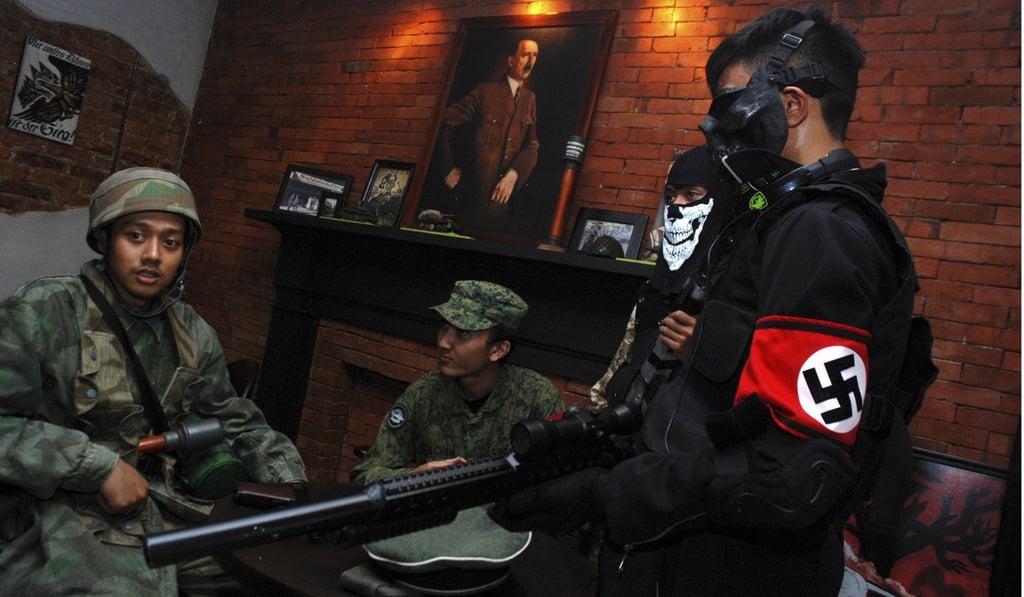 Customers in German uniforms visit a Nazi-themed cafe in Bandung city, western Java island, Indonesia. Photo: AFP