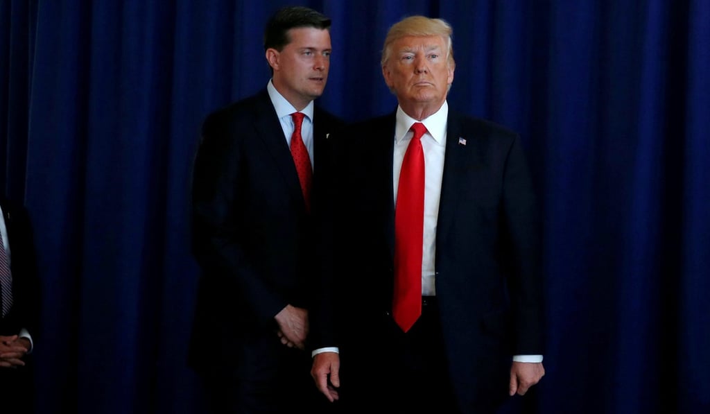 White House Staff Secretary Rob Porter reminds US President Donald Trump of a bill following remarks at Trump’s golf estate in Bedminster, New Jersey, in August. File Photo: Reuters