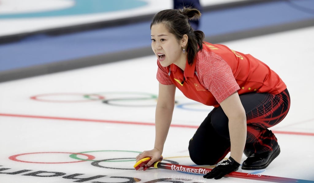 China’s Wang Rui watches teammate Ba Dexin throw a stone during the mixed doubles curling on Thursday morning. Photo: AP