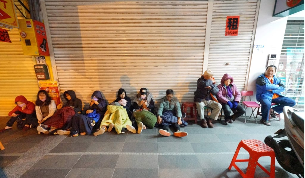 Guests from the damaged Marshal Hotel take shelter outside after the property was badly hit by the quake. Photo: AFP