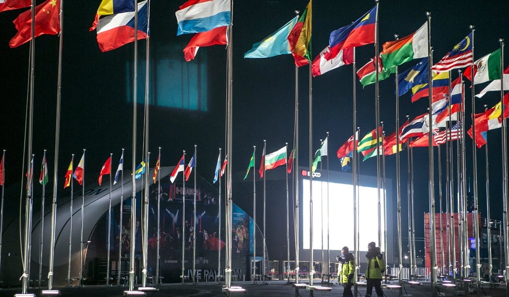 Police patrol the medal plaza as national flags fly ahead of the 2018 Pyeongchang Winter Olympic Games in the Hoenggye-ri village area of Pyeongchang, Gangwon Province, South Korea, on February 8. Photo: Bloomberg
