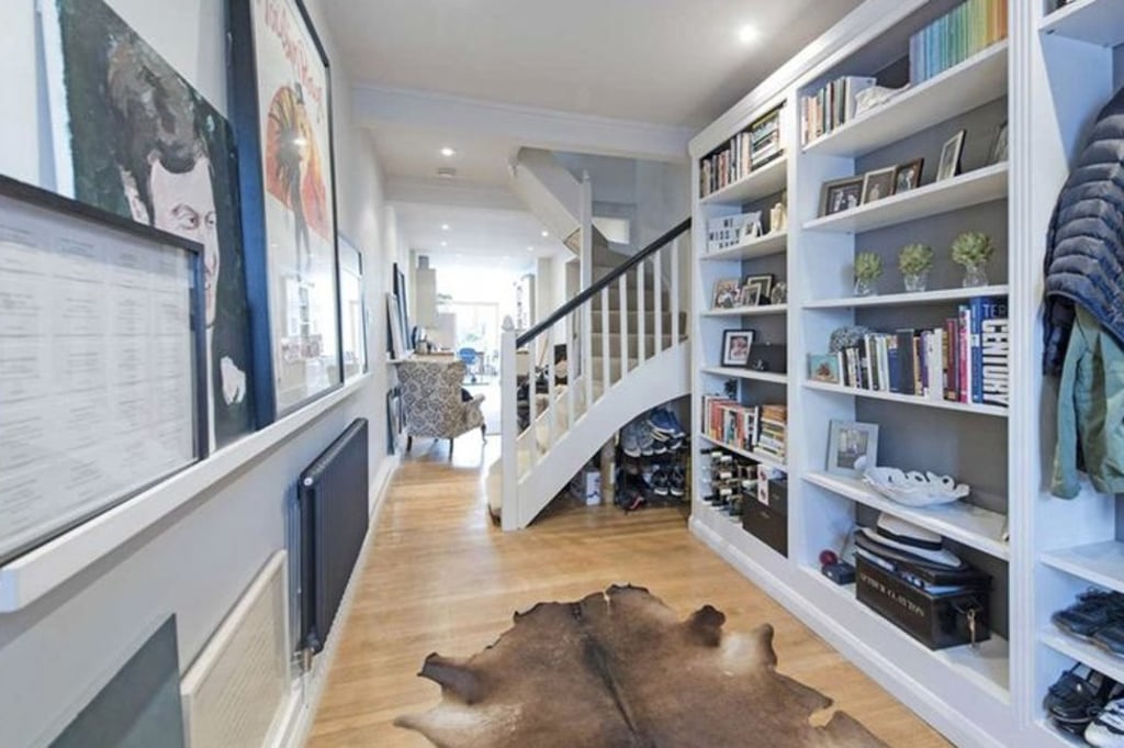The downstairs area features custom-made shelving units to help provide storage. Photo: Savillis.co