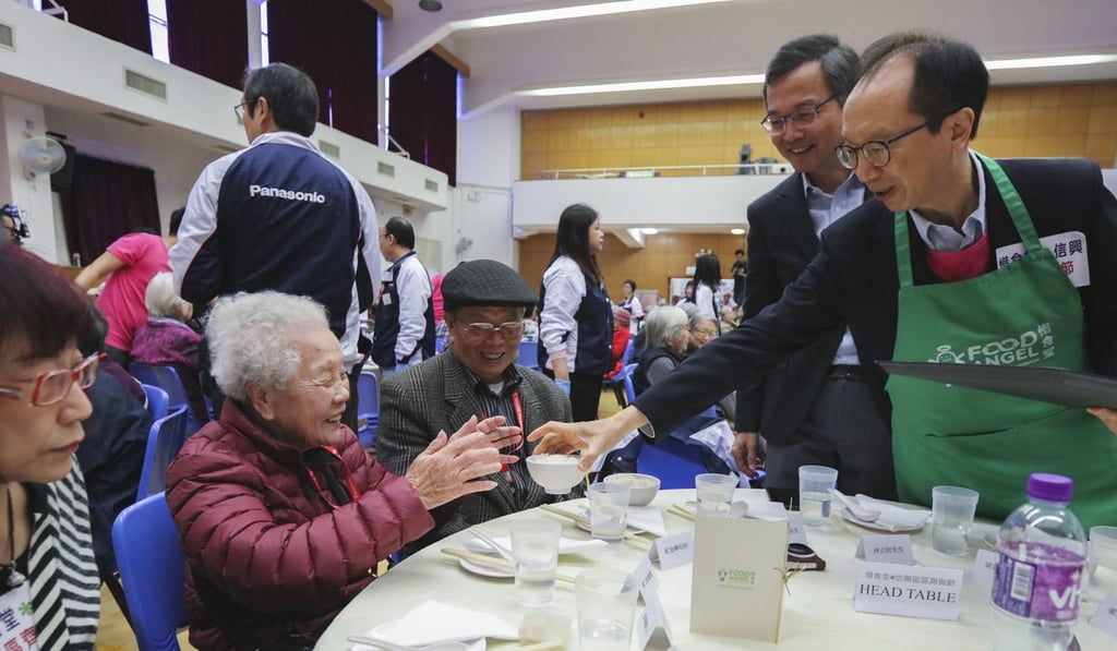 Chairman of the Elderly Commission Dr Lam Ching-choi (second from right) and former financial secretary Anthony Leung Kam-chung (right) attend a Chinese New Year lunch organised by Food Angel in Sham Shui Po. Focusing on programmes to improve the perceived social ties in people’s later life could make a difference in preventing suicide among older adults. Photo: Felix Wong