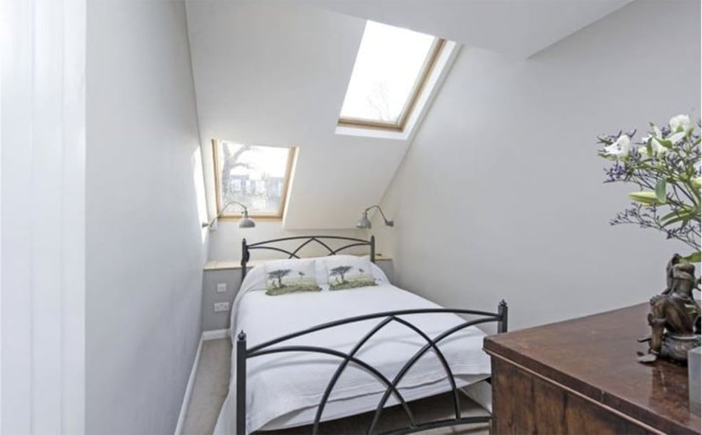 A double bedroom at the property, which features a sloping roof with skylights. Photo: Savillis.com
