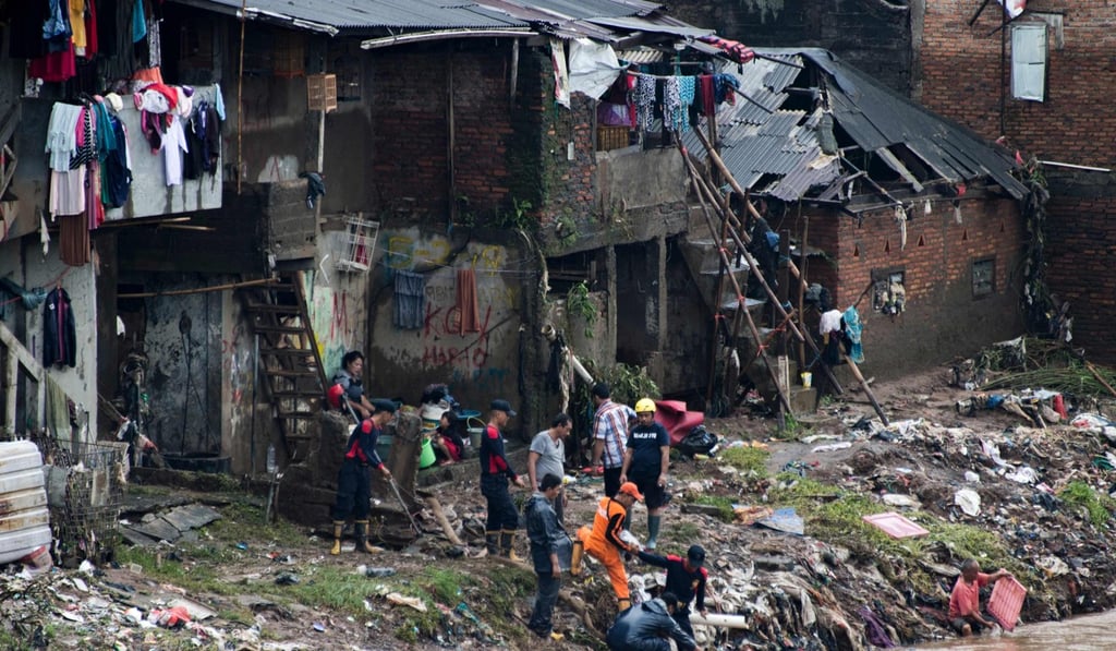 Local government officials use a water pump to drain a flooded neighbourhood after recent heavy rains in Jakarta on February 8, 2018. The UN said a way must be found to handle risks in disaster zones. Photo: AFP