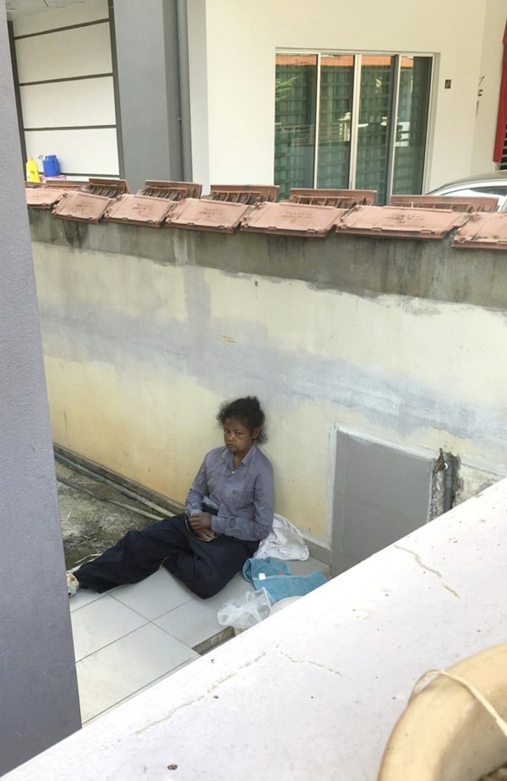 Indonesian maid Adelina Lisao sits on the porch in Bukit Mertajam, near Penang, Malaysia. Photo: AP