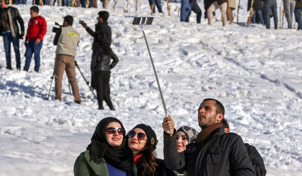 Iraqi Kurds pose for a selfie cellphone photograph in the town of Choman near the Iran-Iraq border. Photo: Agence France-Presse