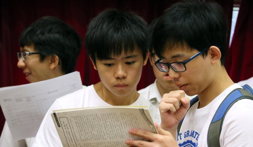 Students collect their DSE results at their school in Causeway Bay. Only one-third of boys gained the minimum scores required to attend university compared to almost half of the girls who took the exam. Photo: Nora Tam