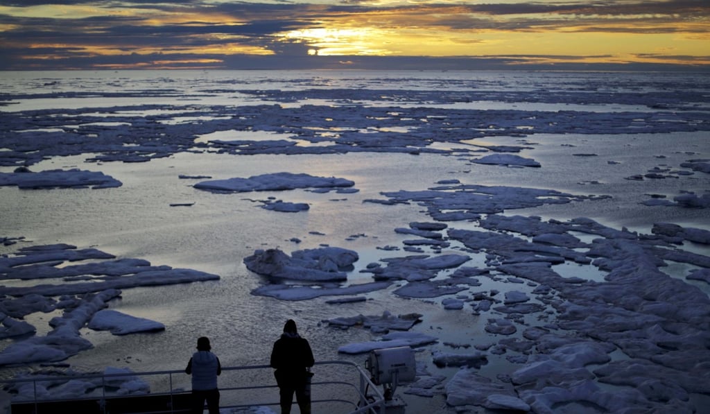 Researchers look out from the MSV Nordica as the sun sets over sea ice floating on the Victoria Strait along the Northwest Passage in June 2017. The Chinese white paper on its policy towards the Arctic, which scientists say is heating up twice as fast as the rest of the planet, won some praise for its emphasis on the environment. Photo: AP