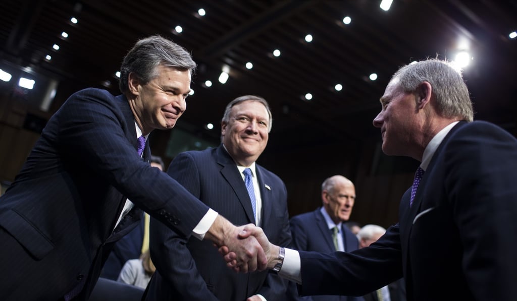 Christopher Wray, director of the Federal Bureau of Investigation, left, shakes hands with chairman Senator Richard Burr, a Republican from North Carolina, before testifying during a Senate Intelligence Committee hearing on worldwide threats in Washington. Photo: Bloomberg Christopher Wray, director of the Federal Bureau of Investigation, left, shakes hands with chairman Senator Richard Burr, a Republican from North Carolina, before testifying during a Senate Intelligence Committee hearing on worldwide threats in Washington. Photo: Bloomberg
