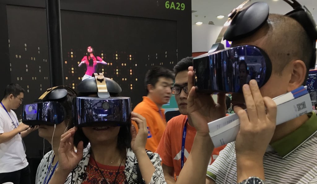 Visitors at the China Hi-Tech Fair 2017 try out a virtual reality headset from iQiyi, a Netflix-style online video-streaming company controlled by Baidu. Photo: Handout