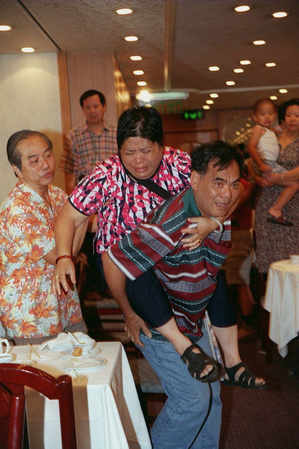 Diners react after a debt-collecting gang release a bag of snakes and grasshoppers in a restaurant in Hong Kong, in 1999. A snake catcher had to be called to round up the 28 non-poisonous reptiles.