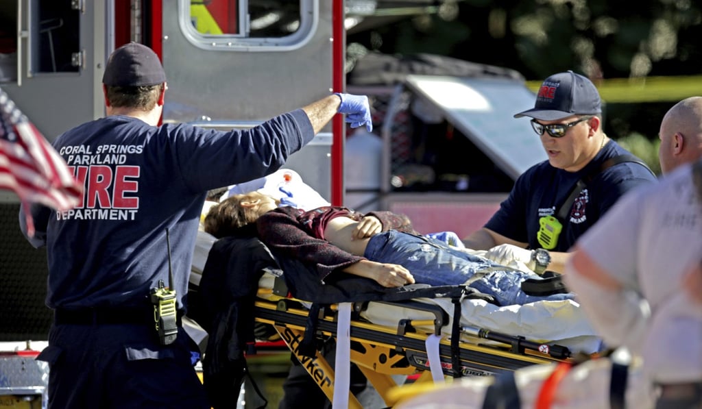 Medical personnel tend to a victim following the shooting at Marjory Stoneman Douglas High School in Parkland, Florida, on Wednesday. Photo: AP Medical personnel tend to a victim following the shooting at Marjory Stoneman Douglas High School in Parkland, Florida, on Wednesday. Photo: AP
