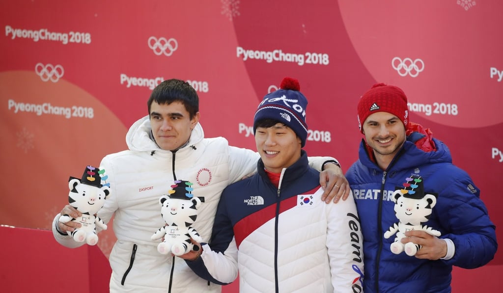 Gold medallist Yung Sung-bin (centre) with Nikita Tregubov (left) and Briton Dom Parsons. Photo: Reuters