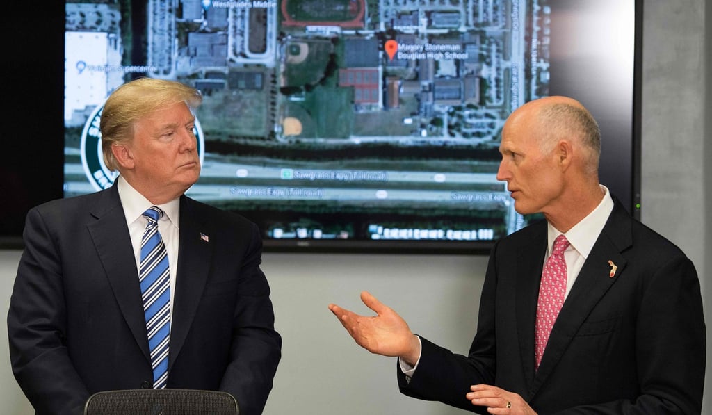 US President Donald Trump speaks with Florida governor Rick Scott. Photo: AFP US President Donald Trump speaks with Florida governor Rick Scott. Photo: AFP