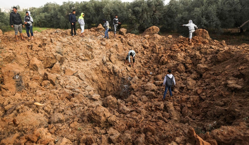 Palestinians check the site of an Israeli air strike in Gaza City. Photo: AFP Palestinians check the site of an Israeli air strike in Gaza City. Photo: AFP
