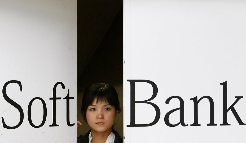 A worker opens a door printed with the Softbank logo, Japan's third-biggest wireless carrier. Photo: Reuters