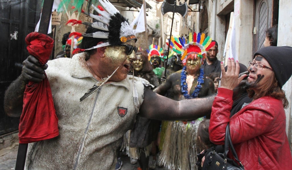 A participant paints the face of a woman during the Zambo Carnival in Tripoli, Lebanon, on Sunday. Photo: Xinhua A participant paints the face of a woman during the Zambo Carnival in Tripoli, Lebanon, on Sunday. Photo: Xinhua