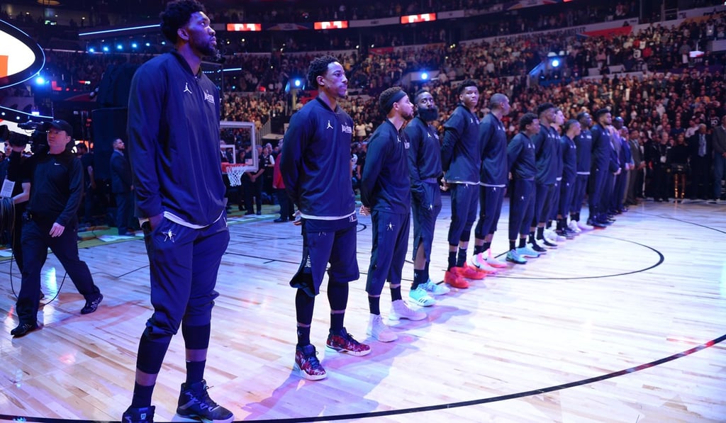 Members of Team Stephen line up on the court for the singing of the National Anthems prior to the start of the NBA All-Star Game. Photo: AFP