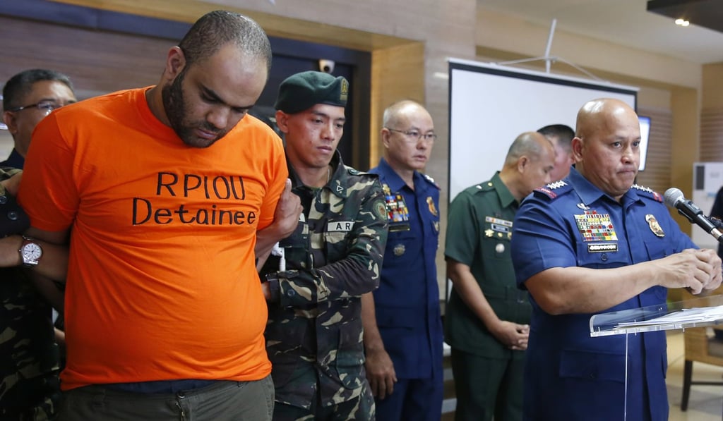 Philippine National Police Chief General Ronald Dela Rosa presents to the media arrested foreigner Fehmi Lassoued on February 19, 2018 at Camp Crame in suburban Quezon City. Photo: AP Philippine National Police Chief General Ronald Dela Rosa presents to the media arrested foreigner Fehmi Lassoued on February 19, 2018 at Camp Crame in suburban Quezon City. Photo: AP
