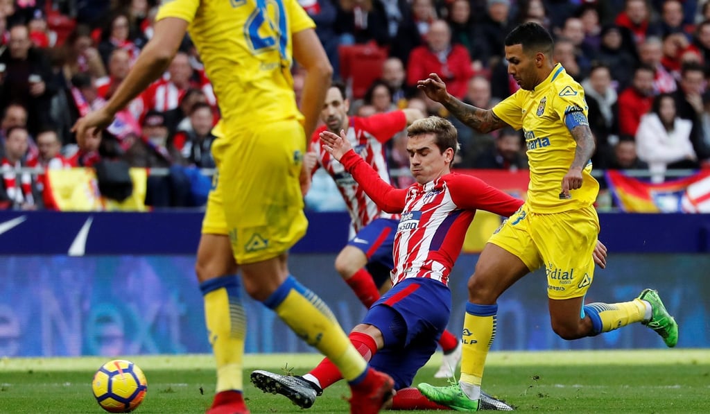 Jonathan Viera (right) tangles with Atletico Madrid’s Antoine Griezmann. Photo: Reuters