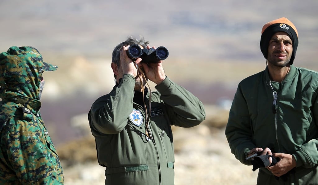 A handout picture released on February 19, 2018 by the Tasnim news agency shows members of a rescue team searching for the wreckage of Aseman Airlines flight EP3704 in Iran's Zagros mountain range. Photo: Ho/Tasnim News via AFP