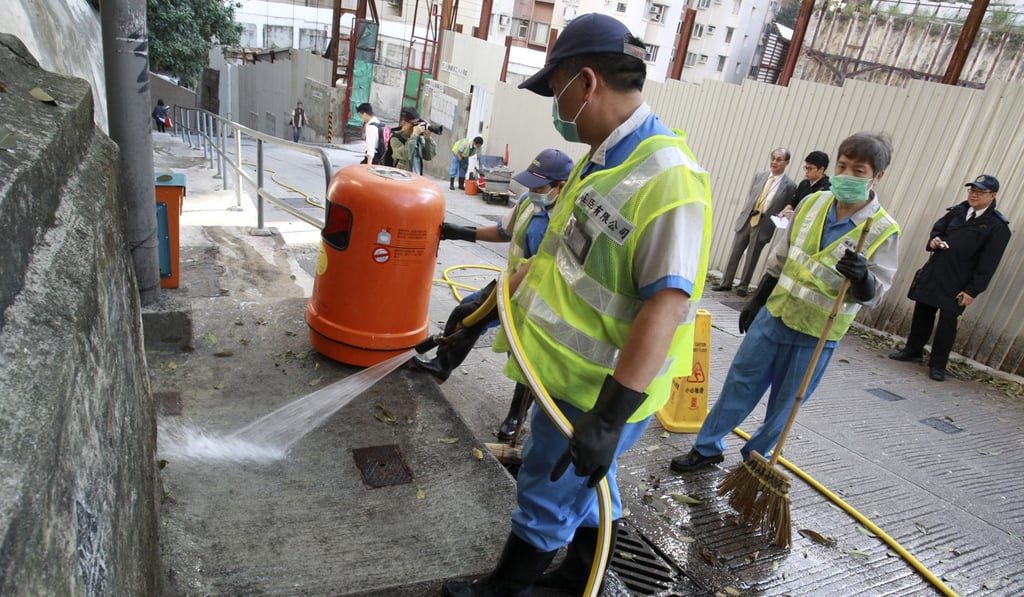 Workers, contracted by the Food, Health and Hygiene Department, hose down the site of a sewage leak in North Point in 2015. The government can encourage the cleaning sector to upgrade and thus attract young talent by changing its procurement policies. Photo: Dickson Lee