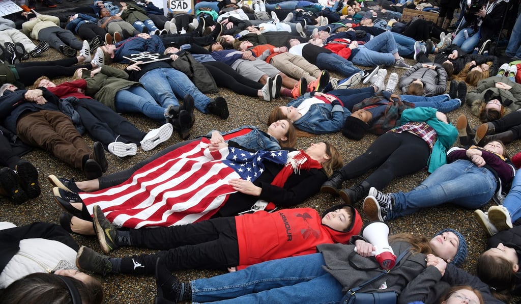 The students lay on the road for three minutes at a time to symbolise the short amount of time it took alleged gunman Nikolas Cruz to gun down numerous people at Marjory Stoneman Douglas High School in Parkland, Florida, last week. Photo: Abaca Press via TNS The students lay on the road for three minutes at a time to symbolise the short amount of time it took alleged gunman Nikolas Cruz to gun down numerous people at Marjory Stoneman Douglas High School in Parkland, Florida, last week. Photo: Abaca Press via TNS