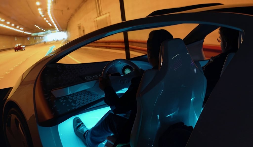 Attendees experience a simulator of Toyota Concept-i Yui, an in-vehicle artificial intelligence assistant, during CES 2018 at the Las Vegas Convention Center on January 9, 2018. Photo: Getty Images/AFP a
