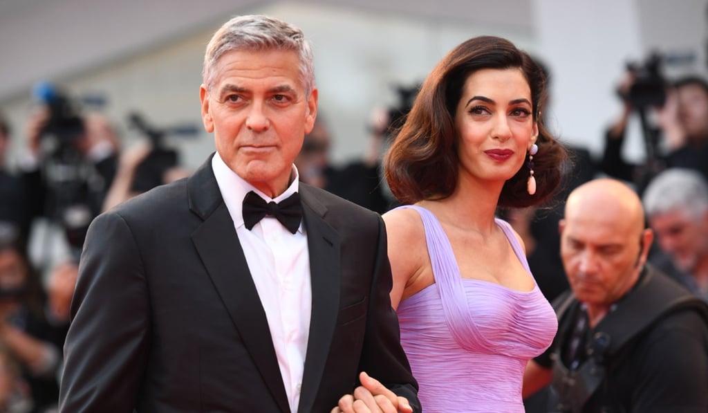 George Clooney and wife Amal (pictured in September last year) are donating US$500,000 to sponsor marches by US pupils in favour of tighter gun laws. Photo: AFP