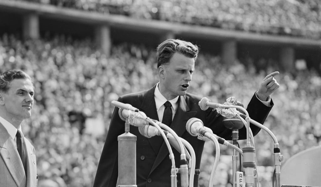 Evangelist Billy Graham speaks to over 100,000 Berliners at the Olympic Stadium in Berlin. Graham, who counselled presidents and preached to millions across the world from his native North Carolina to communist North Korea during his 70 years on the pulpit, died on Wednesday at the age of 99. Photo: AP