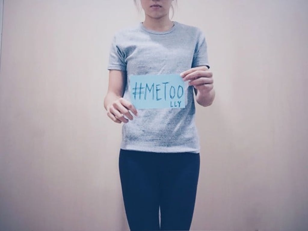 Vera Lui poses with a sign that reads ’‘#METOO’ with her initials ‘LLY’, which she posted on Facebook. Photo: AFP