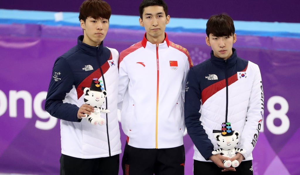 Wu Dajing (centre) with South Korea’s Hwang Dae-heon and Lim Hyo-jun at the medals ceremony. Photo: EPA