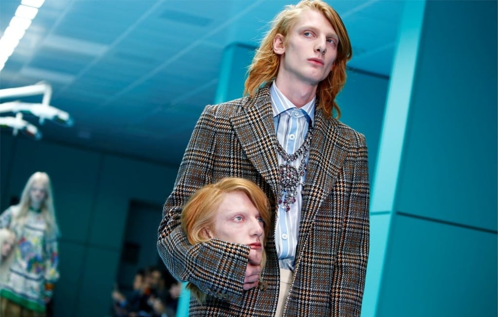 Models carry replicas of their own heads on the runway at Gucci’s show in Milan. Photo: Reuters