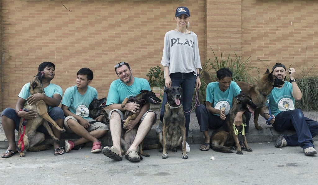 Taking a rest after one of their daily walks: Khouri and staff from Animal Mama (from left) Sothea Sun with Bela, Theara Run with Kaste, Darren Harris with Beatrix, Khouri with Muriel, Sarath Sam with Bonny, and Lee Fox-Smith with Diana. Photo: Enric Catala