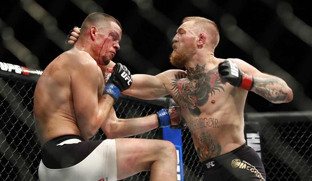 Conor McGregor trades punches with Nate Diaz during their UFC 196 welterweight mixed martial arts match in Las Vegas. Photo: AP