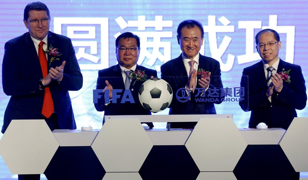 Dalian Wanda’s Wang Jianlin (second from right) joins Fifa officials, and the first vice-president of the Football Association of the People's Republic of China, Zhang Jian (far right) at an event announcing a strategic partnership between the development company and world football’s governing body, in Beijing in March 2016. Photo: Reuters