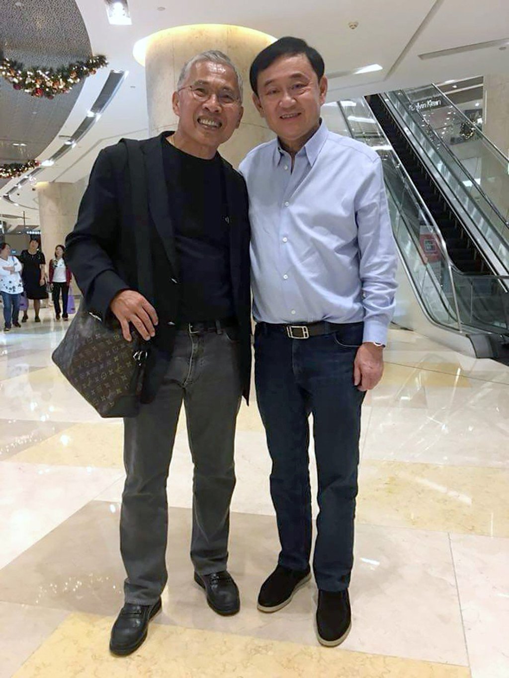 Thaksin Shinawatra, right, with Pheu Thai member Watana Muangsook when the two met this month. Photo: Facebook