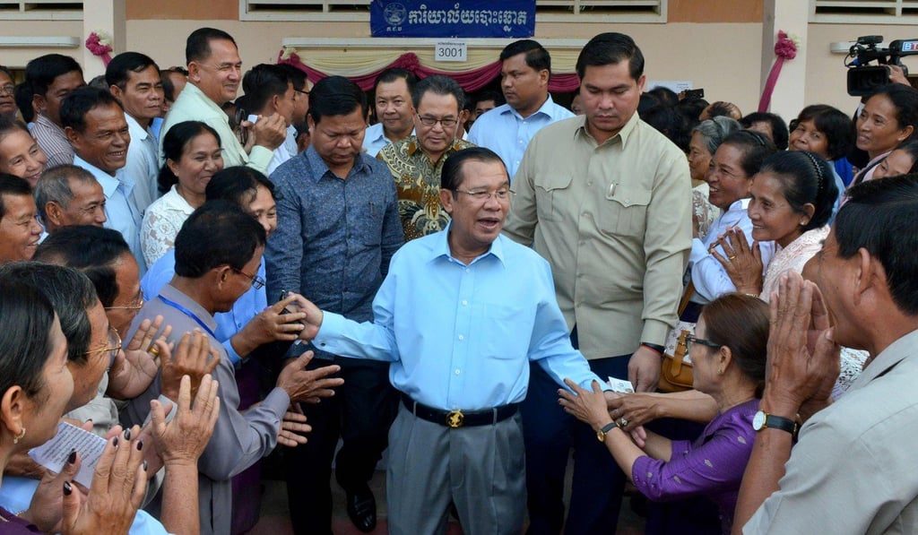 Hun Sen greets commune councillors at a polling station in Kandal province. Photo: AFP Hun Sen greets commune councillors at a polling station in Kandal province. Photo: AFP
