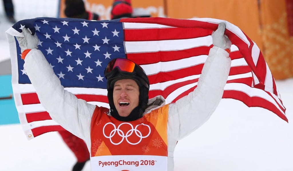 Shaun White of the US celebrates his win as he holds the US flag. Photo: Reuters