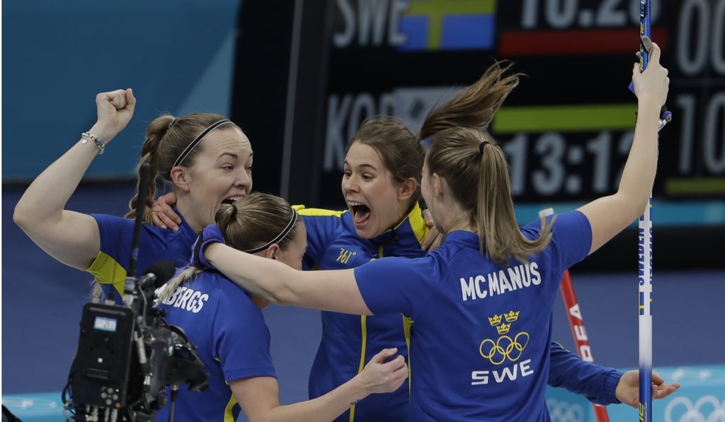 Sweden players celebrate winning the gold medal. Photo: AP