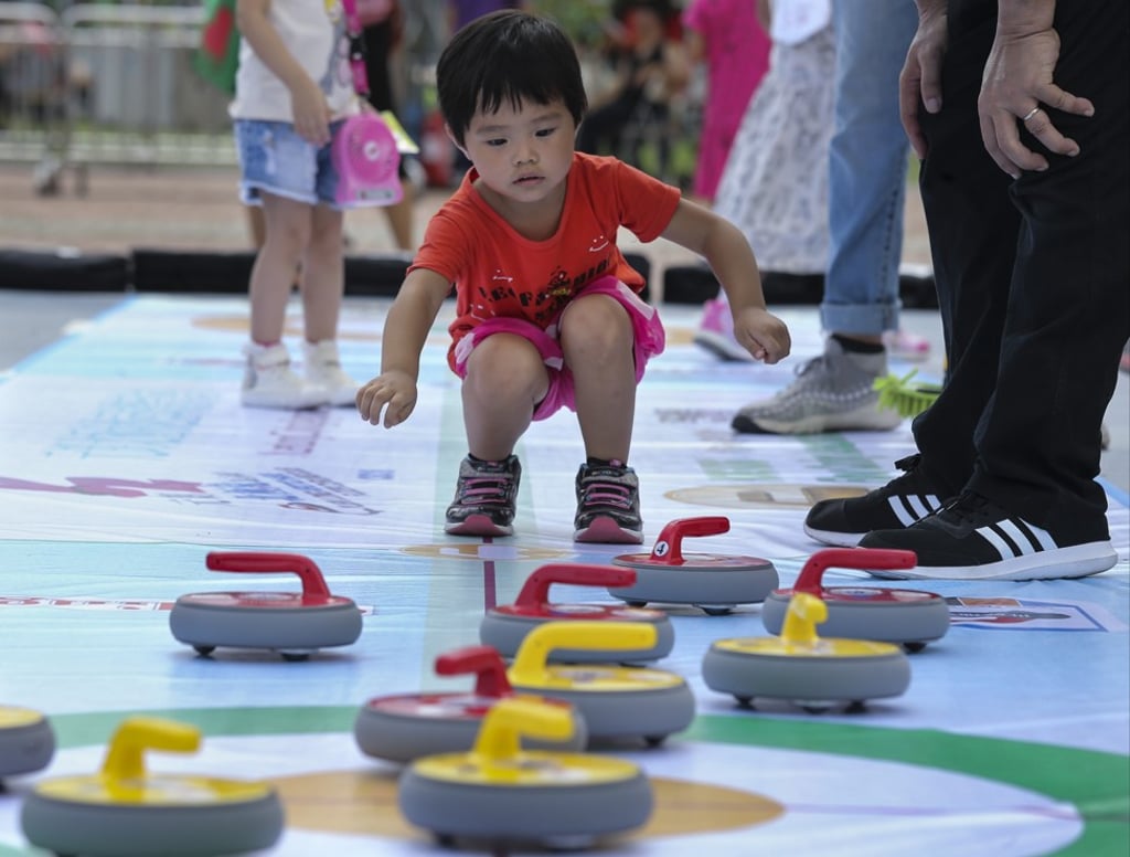 A child tries out floor curling at the Yan Oi Tong 40th anniversary charity carnival and fun day at the Central Harbourfront last year. Photo: Dickson Lee