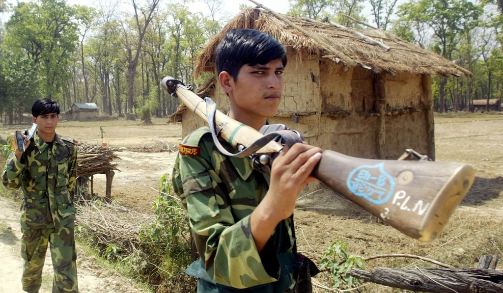 People Liberation Army (PLA) soldiers, a faction of the Maoists, march through a village in the region of Siti Mahakali, around 600kms west of Kathmandu in 2006. Photo: AFP