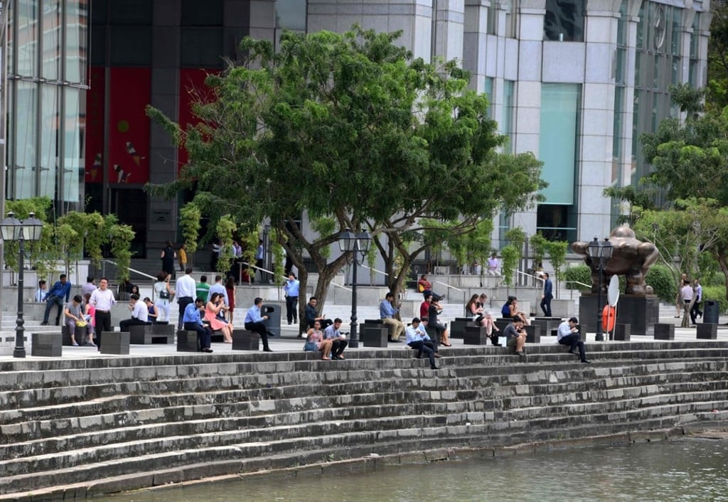 Office workers during lunch break in the financial district of Raffles Place in Singapore. According to HSBC, the mean gross personal annual income of expatriates in the city was US$177,000. Photo: AFP