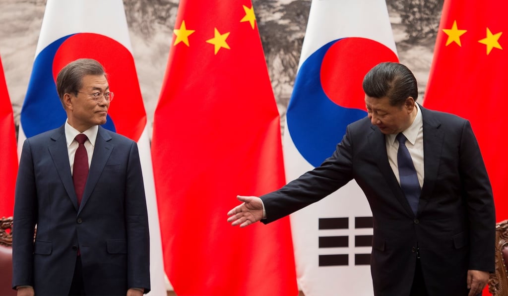 Chinese President Xi Jinping (right) gestures towards South Korean President Moon Jae-in during a signing ceremony at the Great Hall of the People in Beijing on December 14. China has made overtures to a number of countries in the region with which its relationship was troubled in the past, such as Japan, South Korea, Vietnam and India. Photo: Reuters